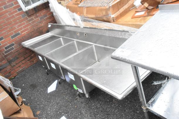 Stainless steel 3-bay sink with dual drain boards, no legs. Clean condition, ideal for commercial use.