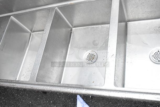 Stainless steel 3 bay sink with dual drain boards, no legs. Clean, minor wear. Ideal for commercial kitchens.