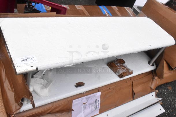 Six new scratch-and-dent items, including a Lancaster Table & Seating Alloy Blue Quartz Outdoor Arm Chair in packaging.