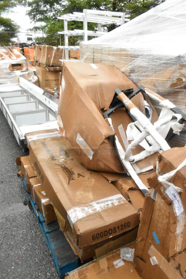 Stack of boxes containing new scratch and dent items, including Regency Stainless Steel Double Deck Overshelf, 600DOS1260.