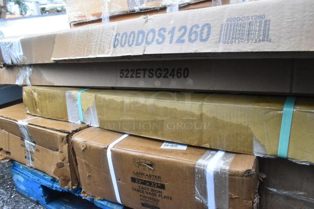 Stack of boxed new scratch and dent items, including Regency overshelf 600DOS1260, Steelton table 522ETSG2460, and Lancaster table base 164TB2222.