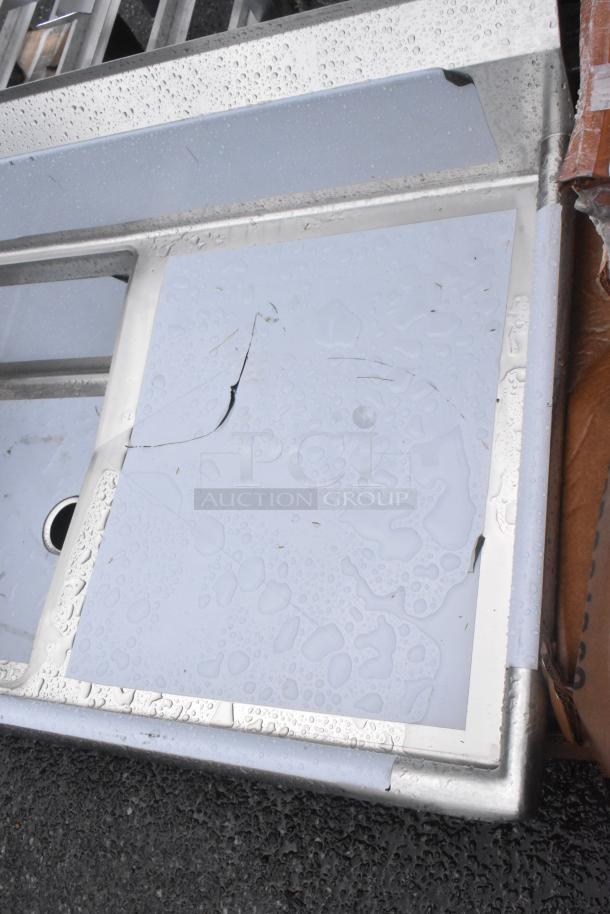 Brand new Regency 600S42424224 stainless steel 4-bay sink, dual drain boards, scratch and dent, missing legs.