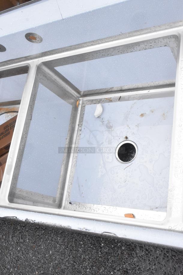 Brand new Regency 600S42424224 stainless steel 4-bay sink. Features dual drain boards, no legs, slight scratches.