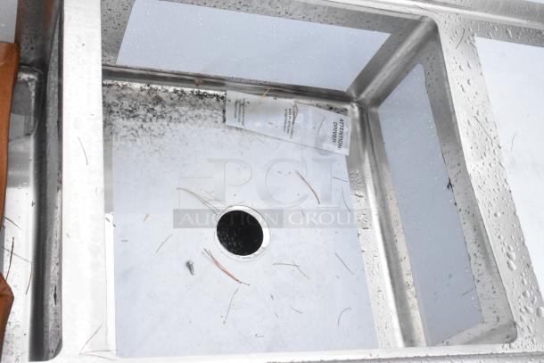 Brand new Regency 600S22323224 stainless steel two-compartment sink with scratch and dent condition, includes galvanized legs and two drainboards.