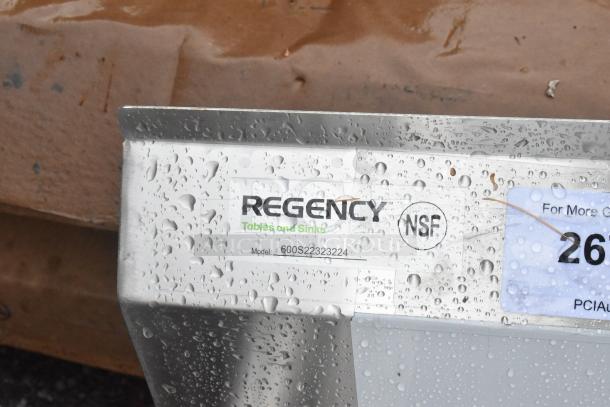 Regency 600S22323224 stainless steel sink, new scratch and dent, 2 compartments, galvanized legs, NSF label visible.