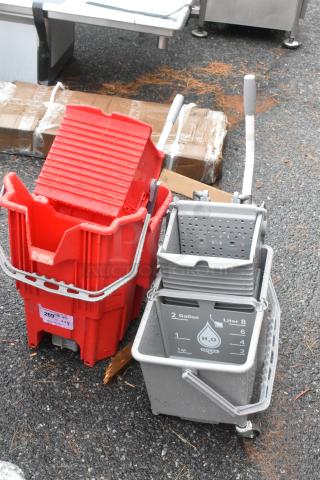 Two brand new scratch and dent poly mop buckets; one red, one gray with measurement markings.