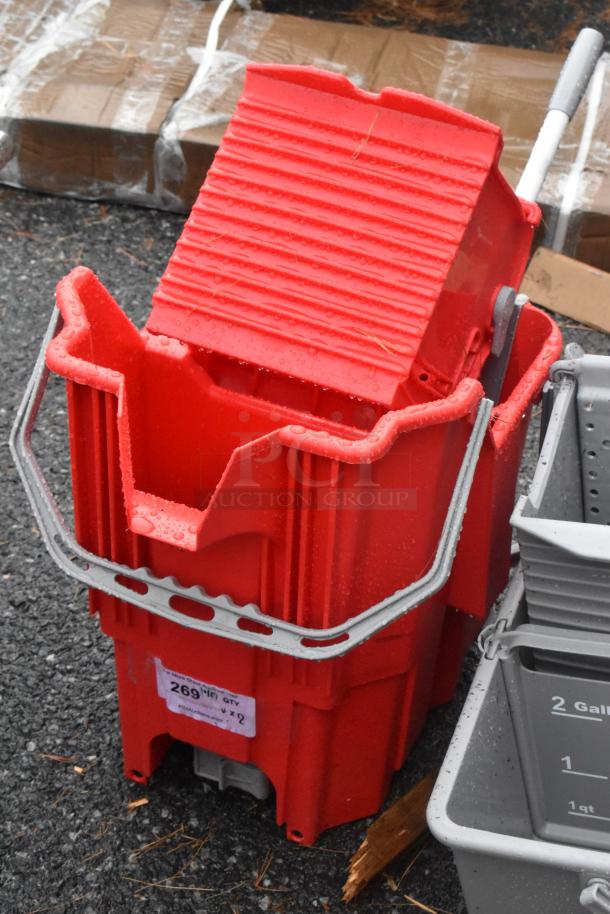 Red poly mop bucket with minor scratches and dents, metal handle, labeled "269". Brand new condition, auction item.