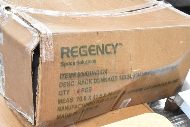 Cardboard box labeled "Regency Space Solutions" containing four 14"x24"x8" aluminum dunnage racks. Box is taped and slightly damaged.