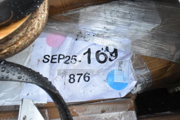 Plastic-wrapped auction lot with visible label showing "SEP25 169" and numbers, indicating mixed condition items.