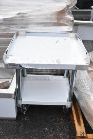 BRAND NEW SCRATCH AND DENT Regency 600ES2424GK 24"x24" stainless steel equipment stand with galvanized undershelf and casters.