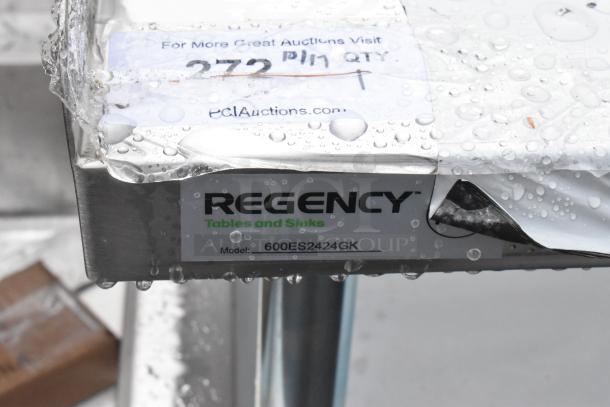 Brand new Regency 600ES2424GK 24" x 24" stainless steel equipment stand, 16 gauge, with galvanized undershelf, casters, label visible.