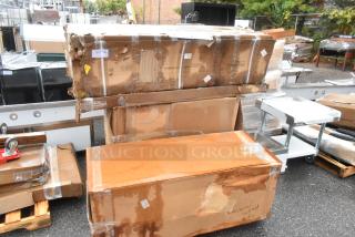 Cardboard boxes containing 4 new Regency stainless steel kitchen items, scratch and dent condition, labels visible.