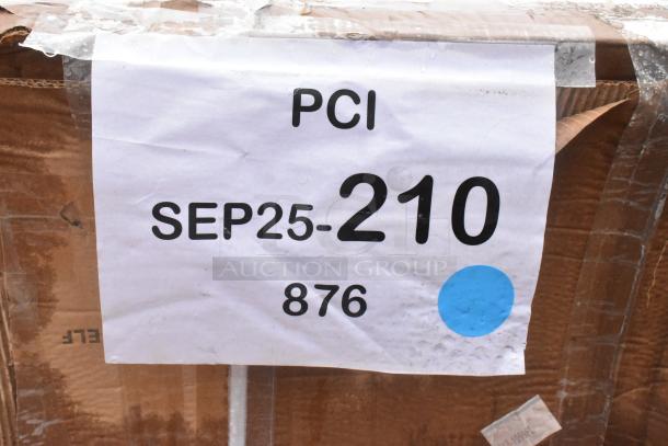 Cardboard box labeled "PCI SEP25-210 876" with blue dot. Contains new Regency stainless steel kitchen items.