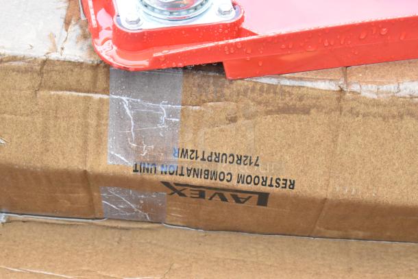 Corner of a red dolly on a damp, taped cardboard box labeled "Lavex 712RCURPT12WR Restroom Combination Unit."