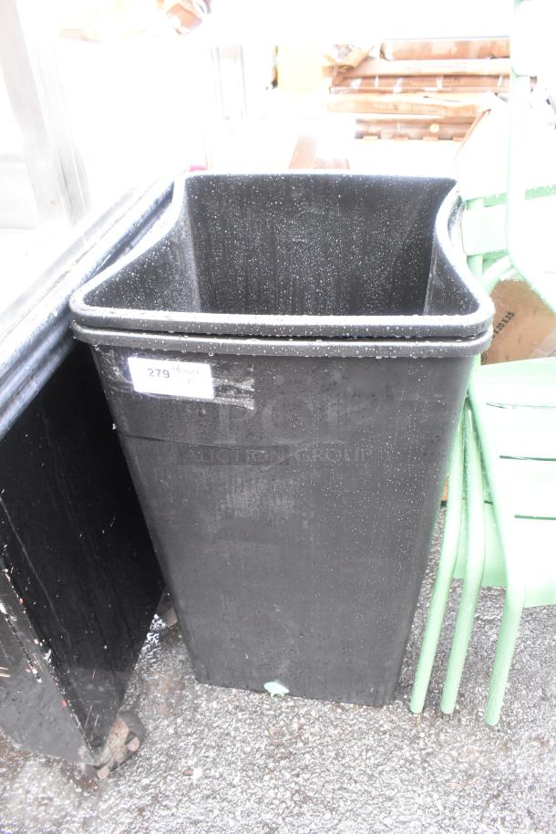 Black poly trash bin, new condition with minor scratches. Visible label reads "279." Suitable for indoor or outdoor use.
