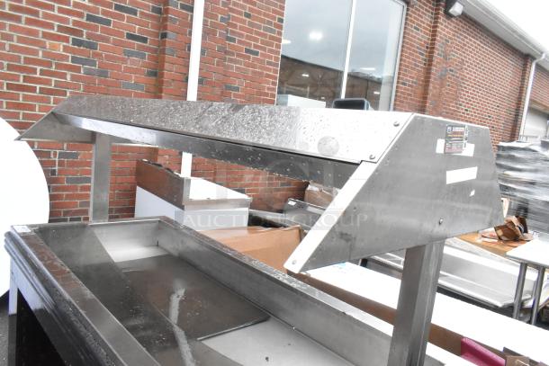 Metal commercial heated buffet station with a sleek design, featuring a stainless steel finish. Ideal for food service.