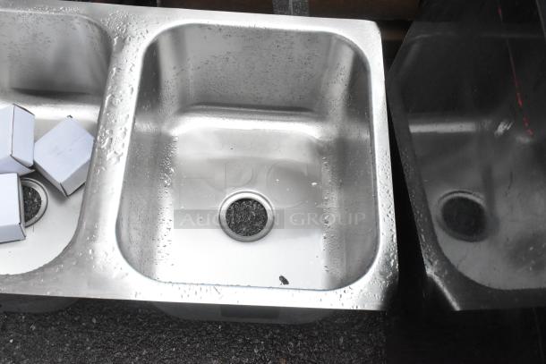 Stainless steel 3-bay drop-in sink, brand new with minor scratches and dents; sleek design with visible water droplets.