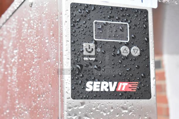 Brand new ServIt Stainless Steel 4 Tier Warming Display Case with control panel, 115V, slight scratches visible, 1 Phase.