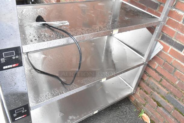 Brand new ServIt stainless steel 4-tier warming display case. 115V, 1 phase. Scratch and dent condition, with visible labels.