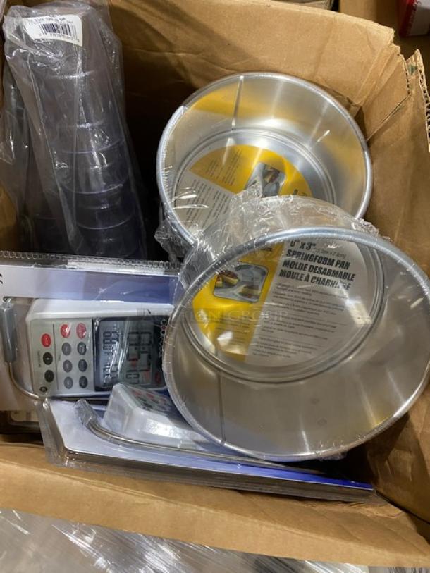 Mixed pallet of commercial kitchen items including Carlisle bowls, Lodge handle holder, and various foodservice tools.