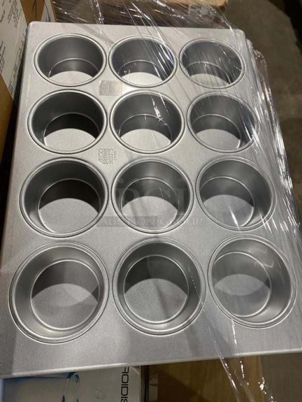 Aluminum 12-cup muffin pan in new condition, wrapped in plastic. Ideal for commercial baking use.