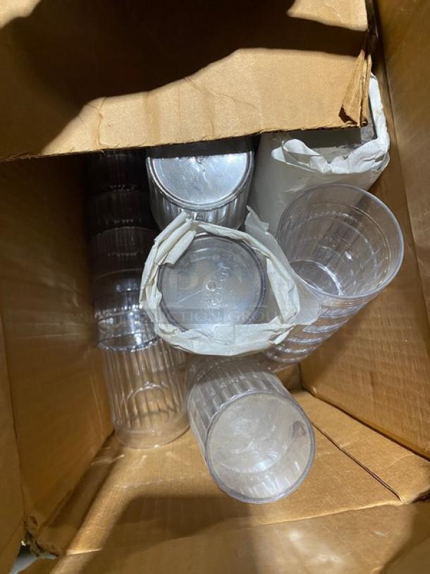 Box containing multiple clear glass items, packed with paper.