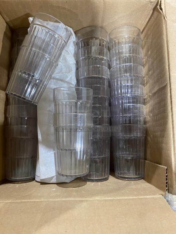 Cardboard box with clear, ribbed stackable glasses, unused and neatly packed.