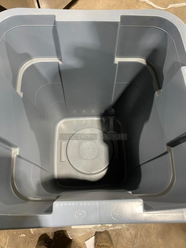 Brand new Rubbermaid Commercial gray square trash can with handles, durable construction, pristine condition.