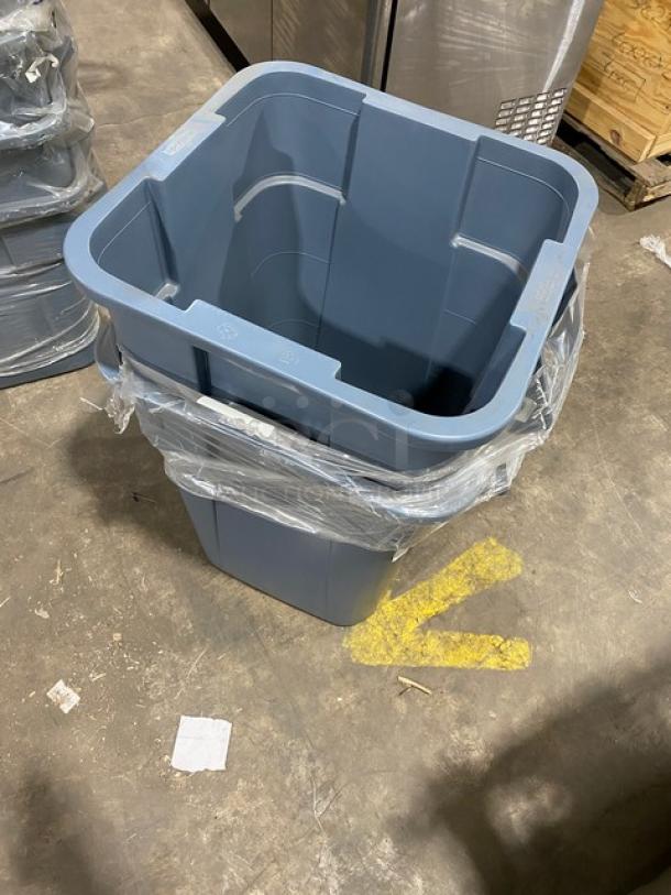 Brand new Rubbermaid Commercial gray square trash can with handles, wrapped in plastic, shown on warehouse floor.