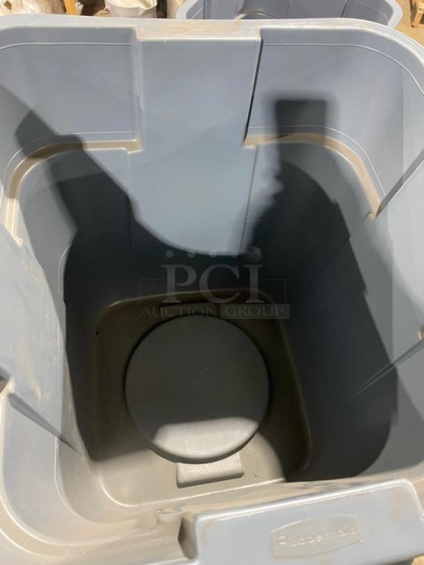 Brand new Rubbermaid commercial gray square trash can/waste bin with handles. Durable construction, ideal for heavy use.