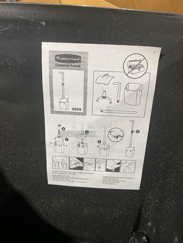 Alt text: Brand new Rubbermaid Lobby Pro Deluxe black upright dustpan, Model FG253300BLA, with assembly instructions visible.