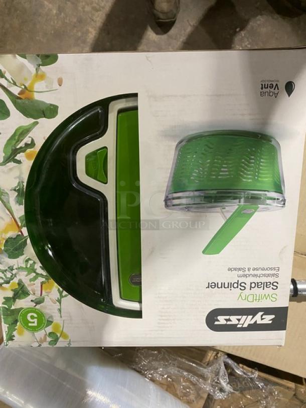 Brand new Zyliss SwiftDry Salad Spinner in box, green lid, single-handed use, AquaVent technology, model shown on packaging.