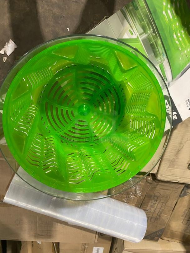 Brand new Zyliss SwiftDry salad dryer, green plastic, commercial-grade, single-handed operation, in packaging.