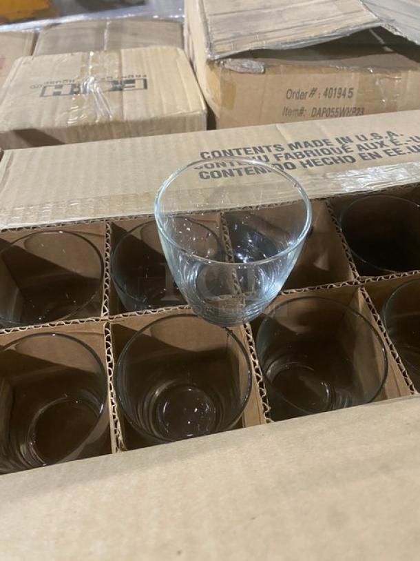 Mixed pallet of new commercial glassware and porcelain dishes in open boxes, featuring a clean display of items from Steelite, Libbey, and Front Of The House collections, ideal for restaurant use.