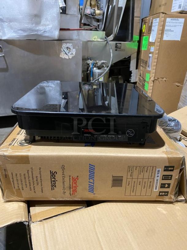 Brand new Spring USA SM-300CR black electric countertop induction warmer on box, sleek design, commercial use.