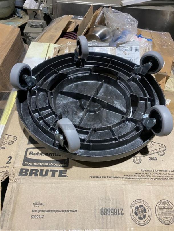 Brand new Rubbermaid BRUTE Series black trash can dolly, model FG264000BLA, on casters.