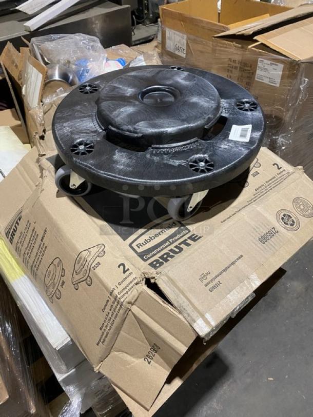 Rubbermaid BRUTE black trash can dolly, model FG264000BLA, brand new on casters, shown on packaging.