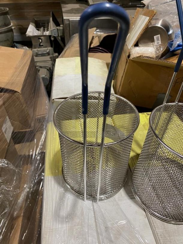 Tablecraft commercial mesh round pasta basket, brand new, with coated blue grip handle, shown alongside another basket.