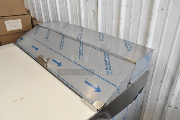 Brand new Beverage Air SPE48HC-12C Elite 48" refrigerated sandwich prep table with 17" cutting board, minor cosmetic dents.
