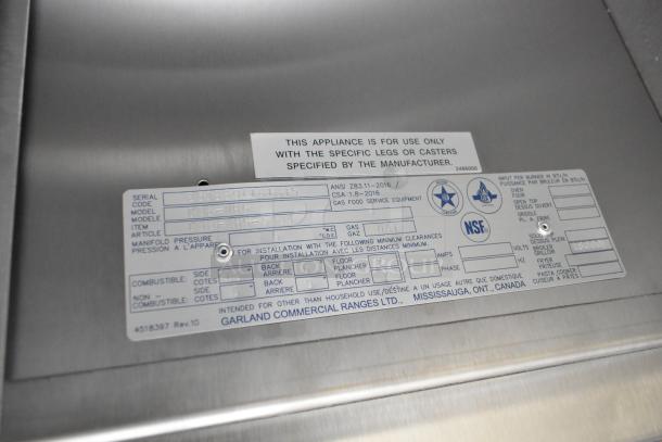 Brand new Garland C36-NRS stainless steel commercial charbroiler grill tag, showing specifications and model details.