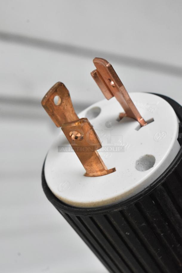 Close-up of a plug fitting for a La Marzocco N/21 2 AV espresso machine, showing copper prongs and a black and white base.