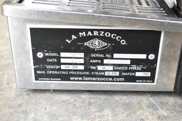 La Marzocco N/21 2 AV stainless steel espresso machine label showing model, voltage (208-240V), and pressure specs.