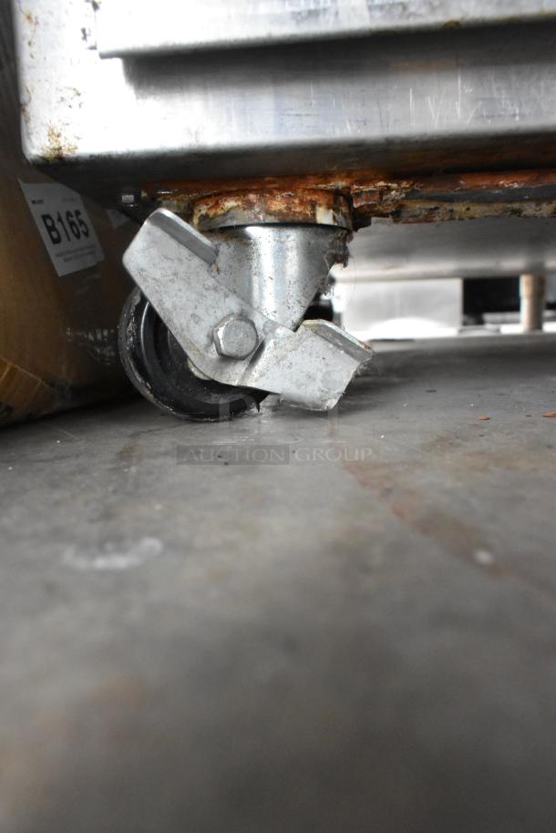 Duke TSC-6/18 stainless steel oven proofer caster, showing rust; Model B165 label visible.
