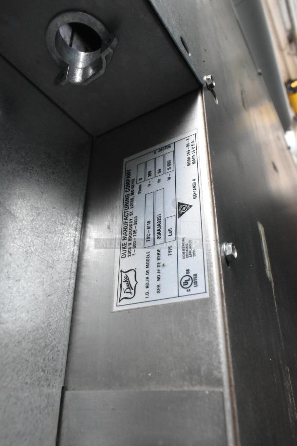 Duke TSC-6/18 stainless steel electric oven proofer, 208V, 3 phase, commercial casters, label with model details visible.
