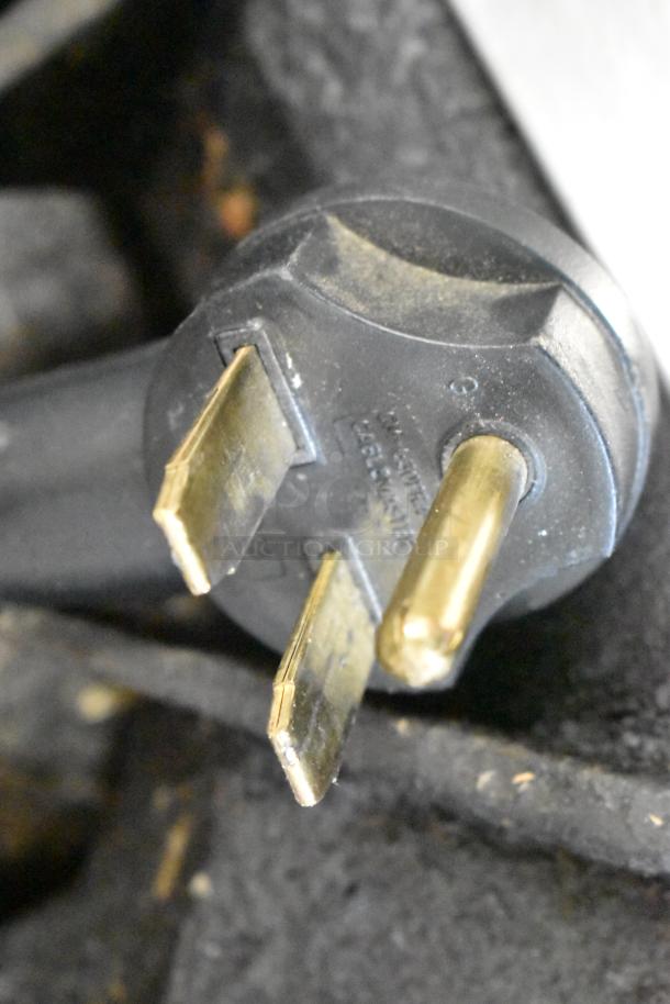 Close-up of a plug for a Turbochef Encore2 rapid cook oven, showing prongs. 208/240V, 1 phase.
