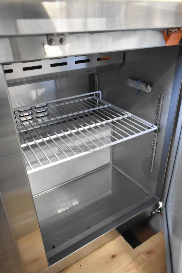 Brand new Avantco 178APT48HC stainless steel commercial sandwich salad prep table. Interior shelving shown. Scratch and dent condition.