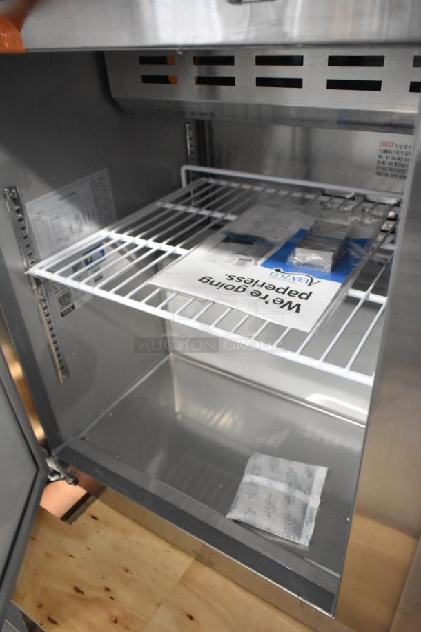 BRAND NEW Avantco 178APT48HC Stainless Steel Prep Table interior, with shelving and paperwork visible.