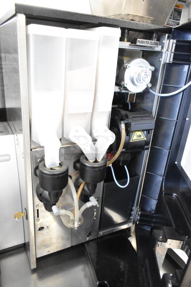 Bunn Crescendo stainless steel bean to cup coffee brewer, model 44300.0201, inside view showing dispensing mechanism.