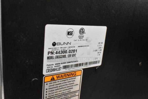 Bunn Crescendo 44300.0201 coffee brewer label shows model, serial number CRSD004187, and safety warnings.