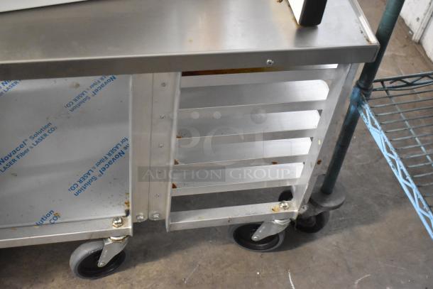 Dutchess DoughXpress DMS-18 NH metal dough press on metal pan rack with commercial casters, used condition.